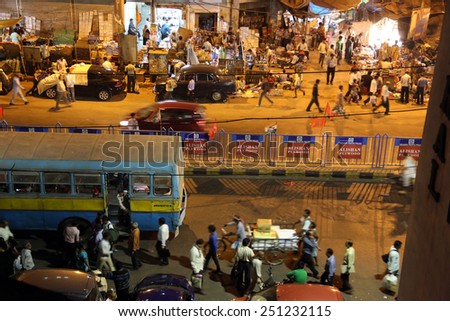 KOLKATA, INDIA - FEB 10: Dark city traffic blurred in motion at late evening on crowded streets on February 10, 2014 in Kolkata. Kolkata has a density of 814.80 vehicles per km road length