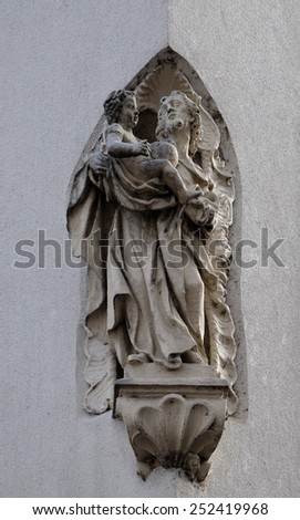 GRAZ, AUSTRIA - JANUARY 10, 2015: Saint Joseph holding baby Jesus, statue on the house facade in Graz, Styria, Austria on January 10, 2015.