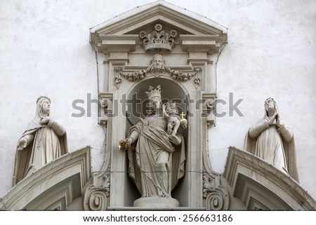 VIENNA, AUSTRIA - OCTOBER 10: Virgin Mary with baby Jesus and Catherine of Siena and Agnes of Montepulciano on the facade of Dominican Church in Vienna, Austria on October 10, 2014.