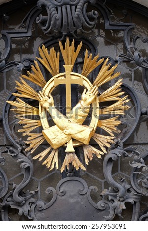GRAZ, AUSTRIA - JANUARY 10, 2015: Franciscan monogram on the main entrance, Mariahilf church in Graz, Styria, Austria on January 10, 2015.