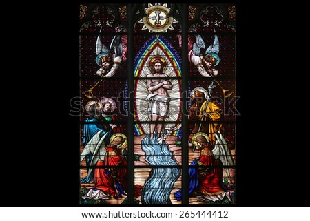 VIENNA, AUSTRIA - OCTOBER 11: Baptism of the Christ, Stained glass in Votiv Kirche (The Votive Church). It is a neo-Gothic church located on the Ringstrabe in Vienna, Austria on October 11, 2014