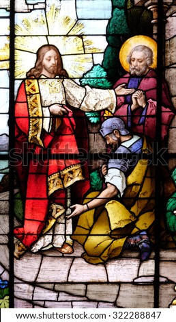 ZAGREB, CROATIA - MAY 28: Jesus and the centurion. Lord, I am not worthy to have you come under my roof..., stained glass in the Basilica of the Sacred Heart of Jesus in Zagreb, Croatia on May 28,2015