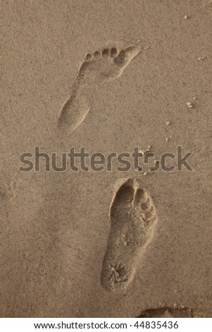 Human trace of a foot on yellow sand
