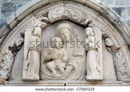 Statue of the Virgin Mary with baby Jesus on the portal of the church of St. Mary of Mercy