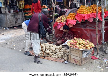 KUMROKHALI, INDIA - JANUARY 12: Tribal villagers bargain for vegetables on January 12, 2009. Kumrokhali, West Bengal, India. 42% of India falls below the international poverty line of $1.25 a day