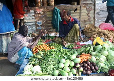 SONAKHALI, INDIA - JANUARY 17: Tribal villagers bargain for vegetables on January 17, 2009. Sonakhali, West Bengal, India. 42% of India falls below the international poverty line of $1.25 a day.
