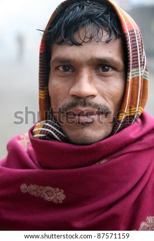 KOLKATA - JANUARY 14: Portrait of a day laborer January 14, 2009 in Kolkata, India. These men sit on the street hoping to get day jobs not paid more than 2,5 dollars a day.