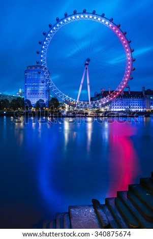 LONDON, ENGLAND - NOVEMBER, 2015, View of The London Eye with French flag colors at sunrise - London tribute to Paris attacks
