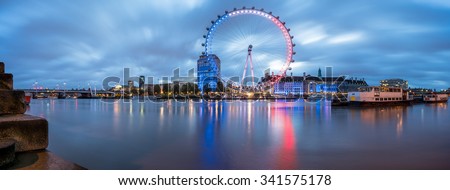 LONDON, ENGLAND - NOVEMBER, 2015. Panorama of The London Eye with French flag colors and two boats at sunrise - London tribute to Paris attacks