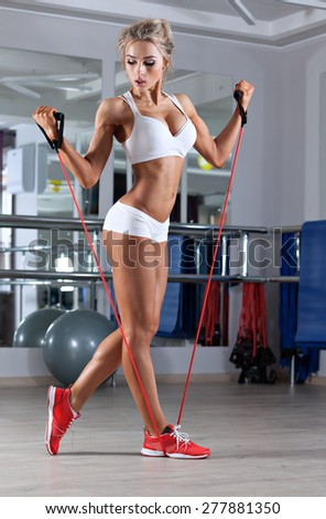 Woman doing exercise with skipping rope in the gym