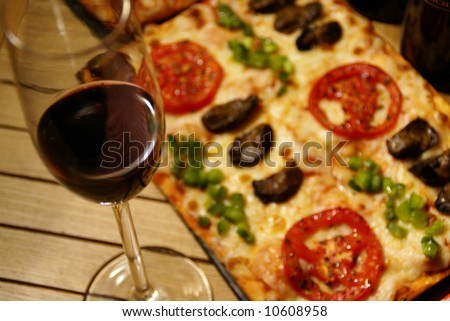 PIZZA open-faced baked pie of Italian origin, consisting of a thin layer of bread dough topped with spiced tomato sauce and cheese, often garnished with anchovies, sausage slices, mushrooms