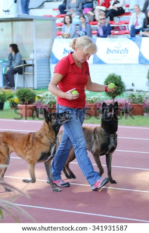 Wroclaw, Poland - 9/27/2014. Women and her dogs during obedience training at the International pure breed dog exhibition. Documentary editorial image.