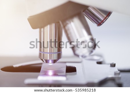 Laboratory Microscope. Scientific research background with light effect.