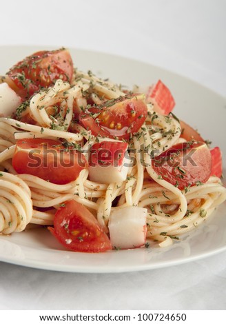 pasta with crab and cherry tomatoes close up