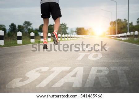 Athletic young man running on the road with text 2017 year, Start to new year. Happy new year concept.