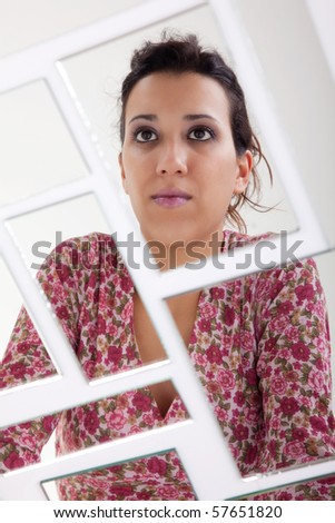 woman on mirror, broken. Studio shot
