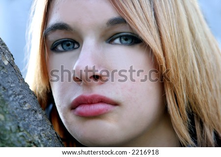 stock photo Close up of blond teen age girls face with blue eyes