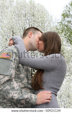 Army Soldier kissing his girl friend goodbye