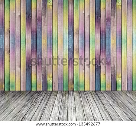 Multi-colored wall from wood and a gray wood floor, the empty room