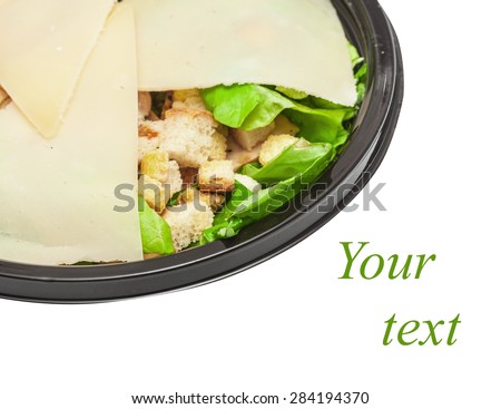 Griddled chicken caesar salad covered with cheese slices parmesan isolated on white background