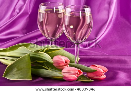 Two glasses of white wine and flowers