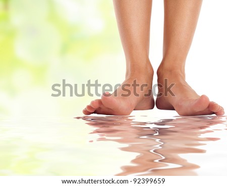 female feet with splayed fingers on water - spa and healthcare concept