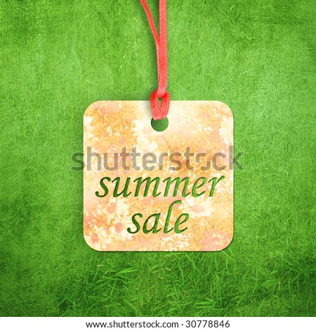 Sale label on grass background