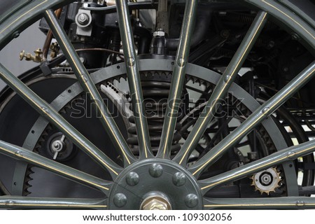 Close to a wheel of one of the first cars