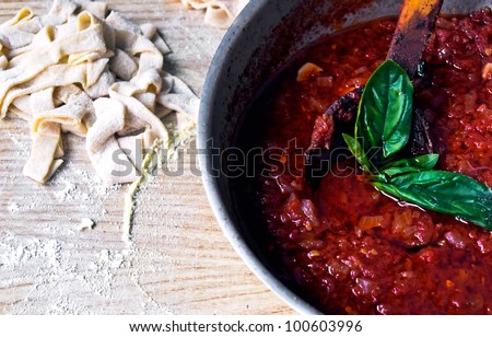 Fresh Tagliatelle and court with tomato sauce