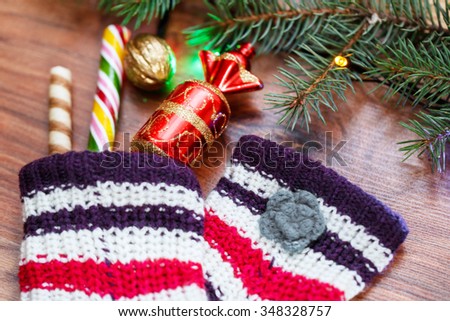 Sweets and toy from woolen socks, wooden Christmas background, card for the winter holidays, xmas, Christmas and New Year