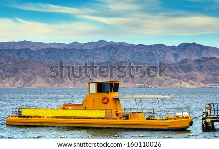Pleasure boat with a transparent bottom for watching of corals, Red Sea, Eilat