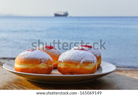 Hanukkah donuts with jam on background of the Red Sea, Israel