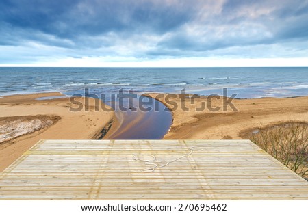 Wooden deck floor over of sand beach of the Baltic Sea