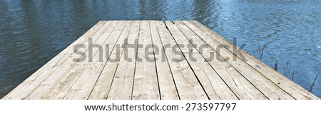 Old wooden deck floor over blue water