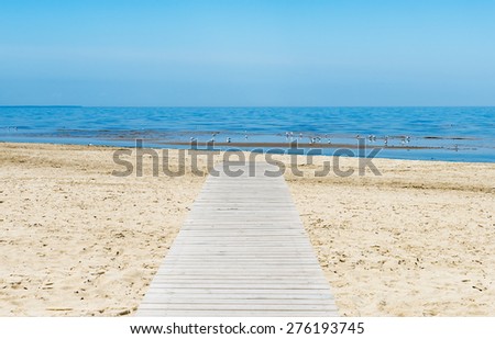 Coastal landscape with wooden board at sandy beach, Baltic Sea, Europe