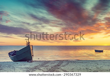 Sunrise at sandy beach of the Baltic Sea, Europe. Image slightly toned in vintage warm colors style