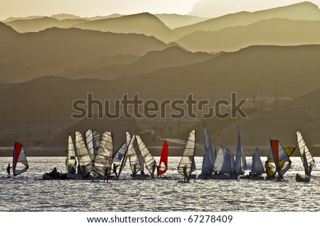 view on mountains of Eilat and yachts at sunset during dust-storm, Israel