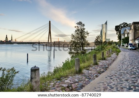 View on stay cables of modern bridge and old buildings from left bank of Daugava river, Riga, Latvia