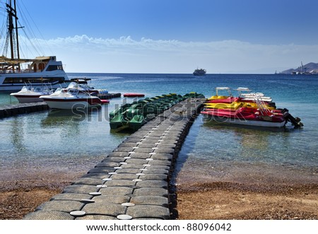 View on the Aqaba gulf (Red Sea) and pier with recreation facilities,northern beach of Eilat, Israel