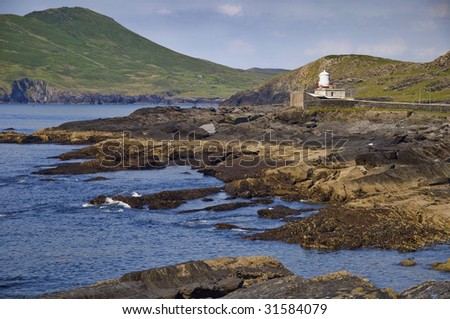remote coastal old lighthouse seascape with mountain landscape