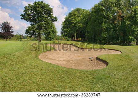 golf sand bunker in scenic location trees and blue sky