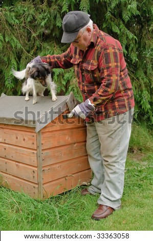 senior male preparing dog house for painting