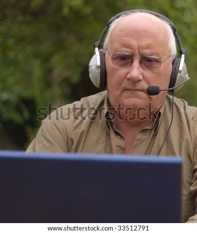 Close-up image of a senior using a laptop and voice call