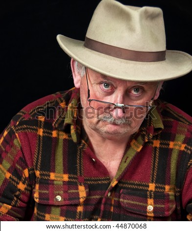 photo of senior male with sad or grumpy face portrait