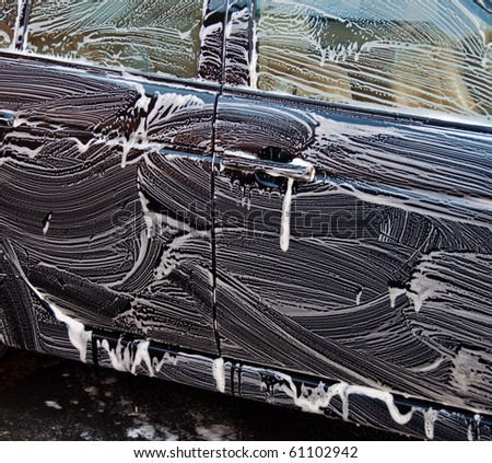 photo dirty car being washed outside with soap