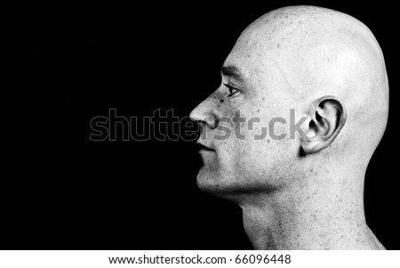 photo high contrast dark moody close up picture of a male head from side on black