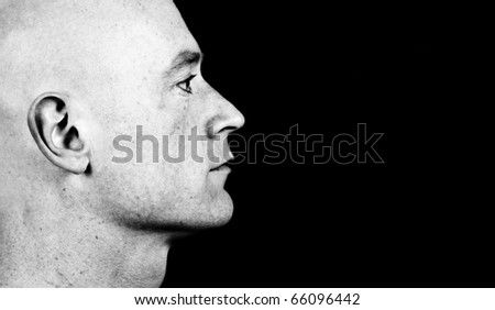 photo high contrast dark moody close up picture of a male head from side on black