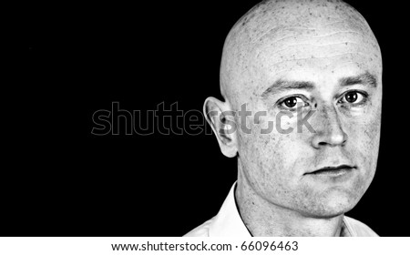 photo high contrast dark moody male in his 30\'s in shirt on black back drop