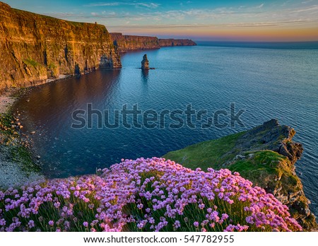 Ireland countryside tourist attraction in County Clare. The Cliffs of Moher and castle Ireland. Epic Irish Landscape Seascape along the wild atlantic way. Beautiful scenic nature hdr Ireland.