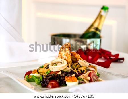 salad of seafood on plate in restaurant